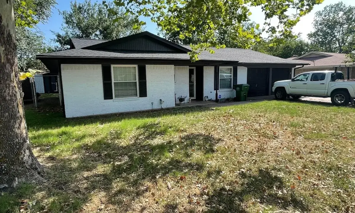 Professional roofing crew working on a residential roof in Harrison